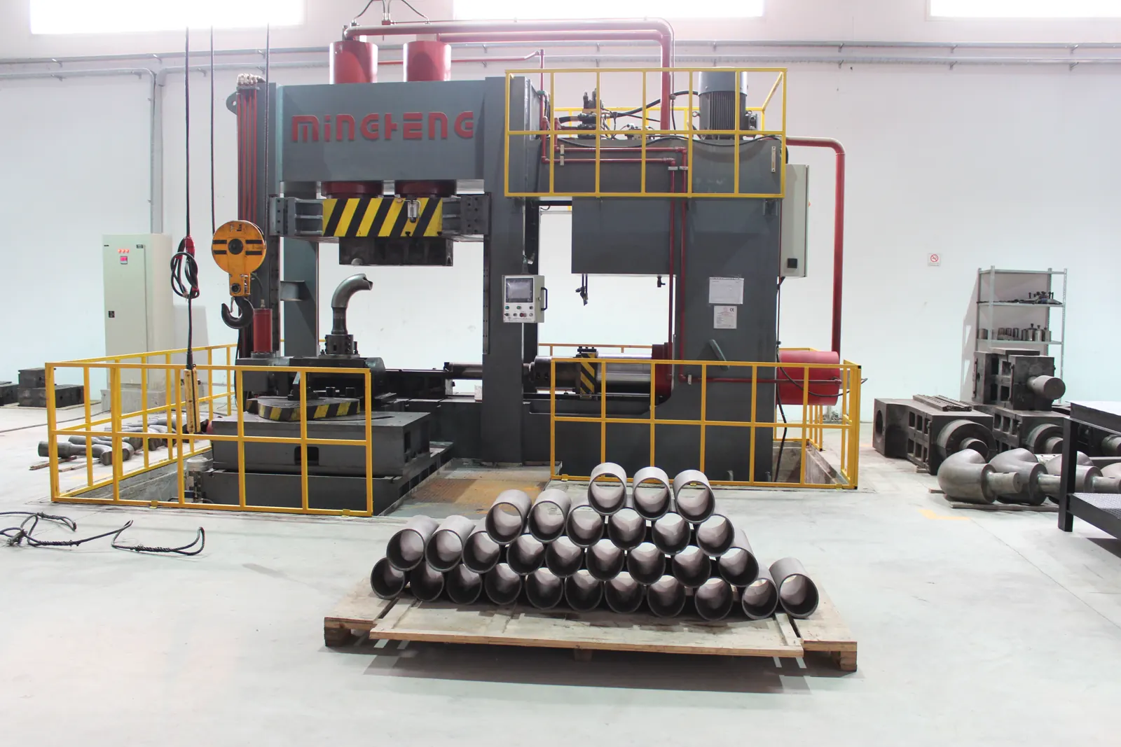 Butt-weld caps stacked next to a forming press at the Sfax plant
